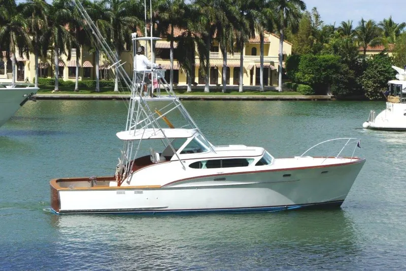 Slide: The Image of 1959 Rybovich Express boat, repowered in 2008, cruising on a scenic waterway. - 2