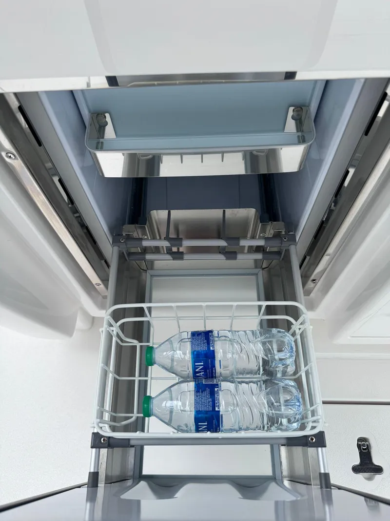 Slide: The Image of Alt text: 2023 Intrepid 427 Nomad FE refrigerator with water bottles inside. - 10