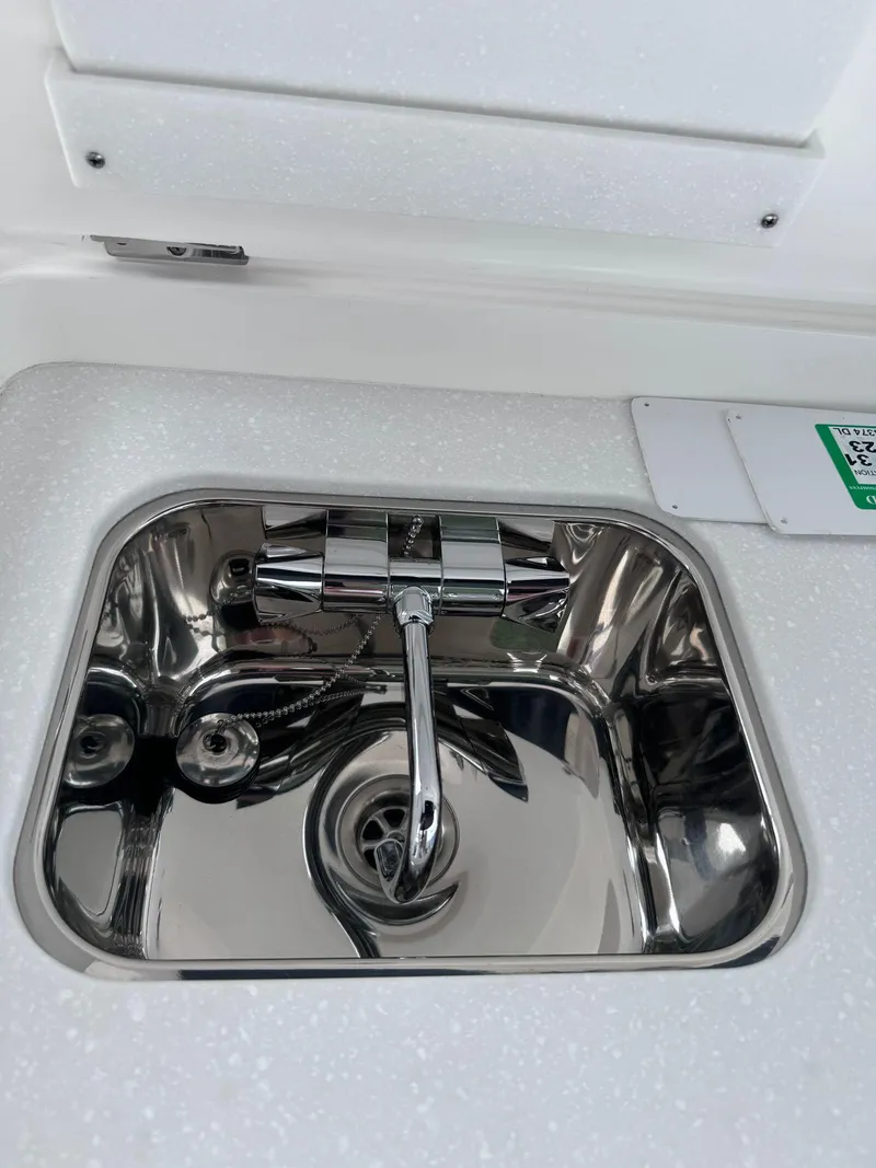 Slide: The Image of 2023 Intrepid 427 Nomad FE stainless steel sink in white countertop. - 12