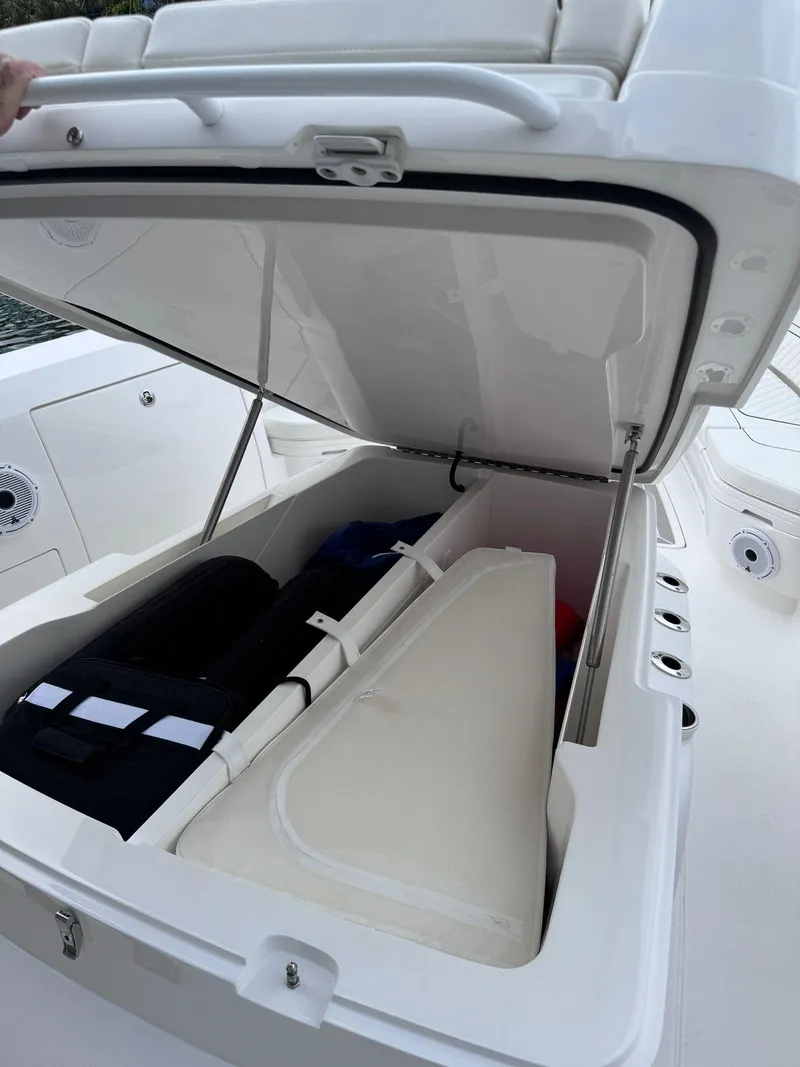Slide: The Image of 2023 Intrepid 427 Nomad FE storage compartment with open hatch. - 16