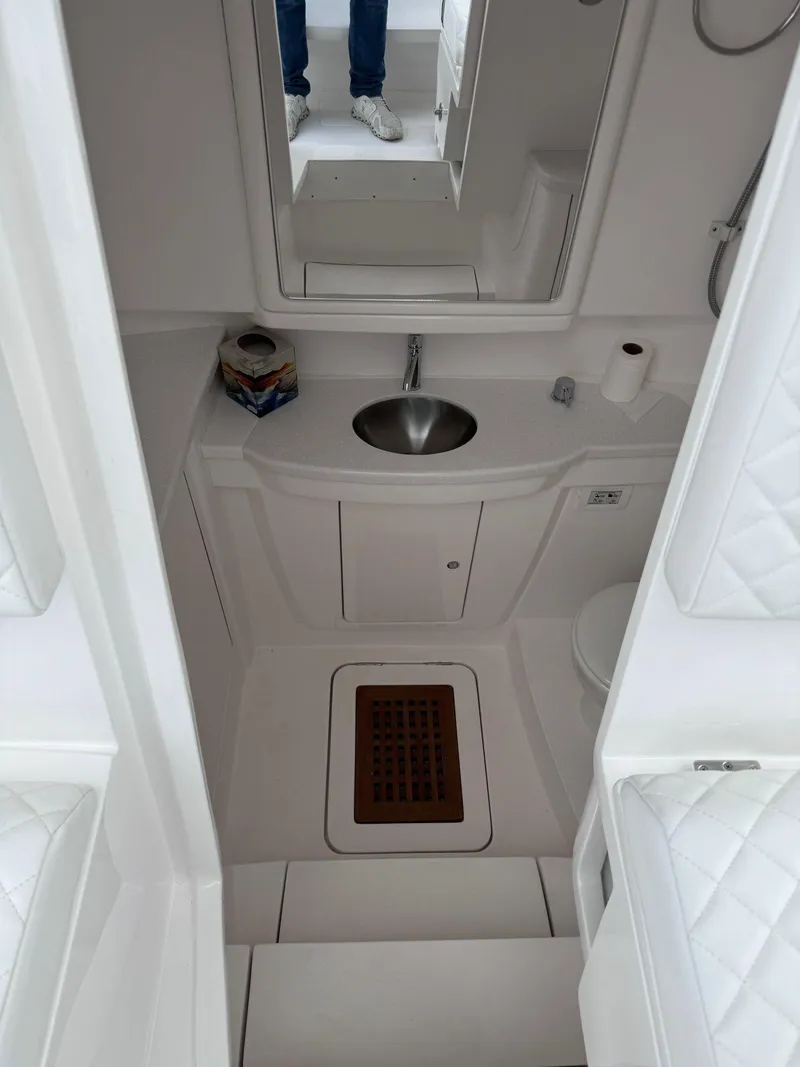 Slide: The Image of 2023 Intrepid 427 Nomad FE boat bathroom with sink, mirror, and toilet. - 22