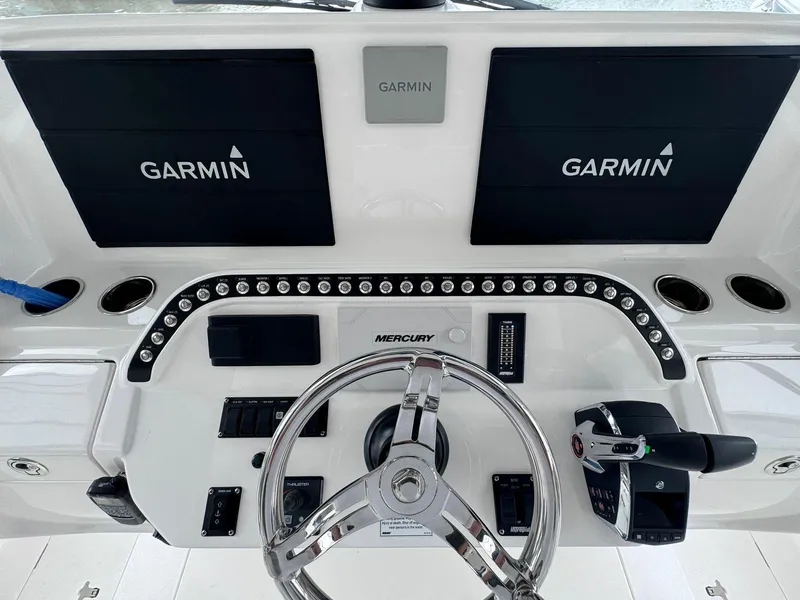 Slide: The Image of 2023 Intrepid 427 Nomad FE boat dashboard with Garmin navigation system and Mercury controls. - 3