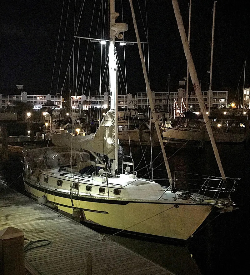 The Image of 2005 Pacific Seacraft 40 sailboat docked at night in a marina. - 0