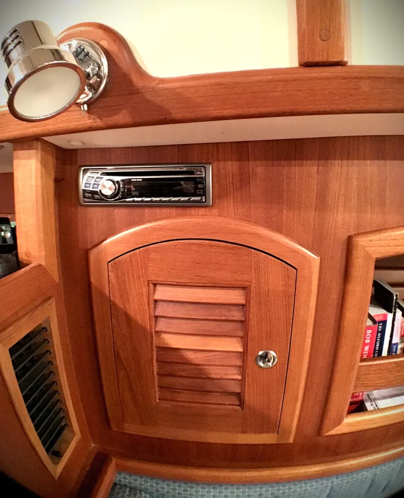 Slide: The Image of Interior of 2005 Pacific Seacraft 40 yacht with wooden cabinetry and stereo system. - 11
