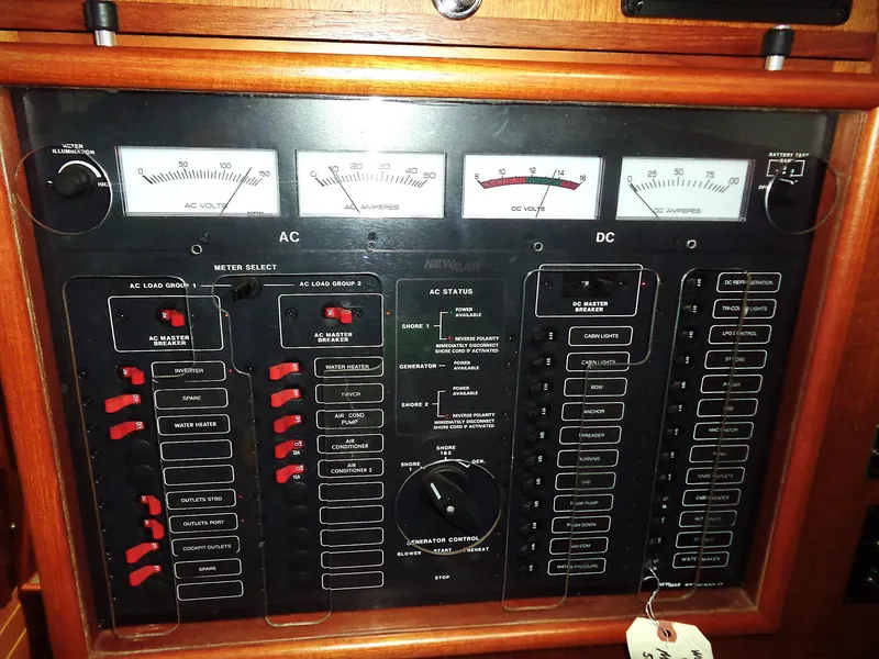 Slide: The Image of Electrical control panel of a 2005 Pacific Seacraft 40 yacht, featuring AC and DC meters. - 13