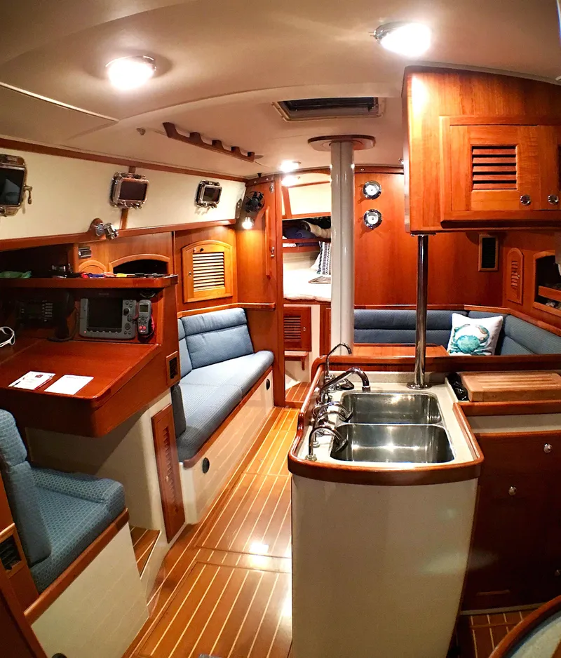 Slide: The Image of Interior of 2005 Pacific Seacraft 40 sailboat with wood finish and blue seating. - 2