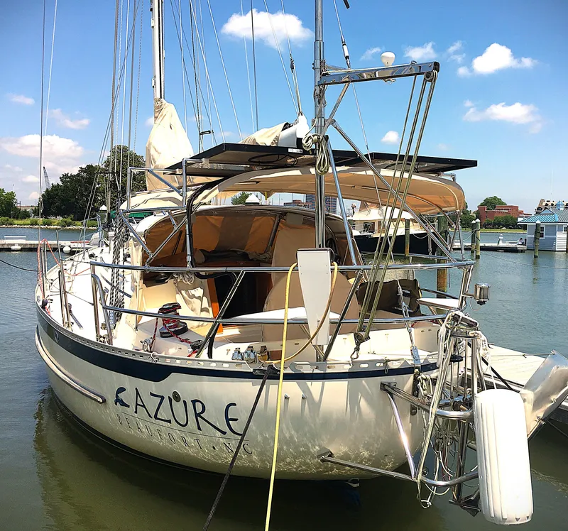 Slide: The Image of 2005 Pacific Seacraft 40 sailboat docked in a marina under a clear blue sky. - 21