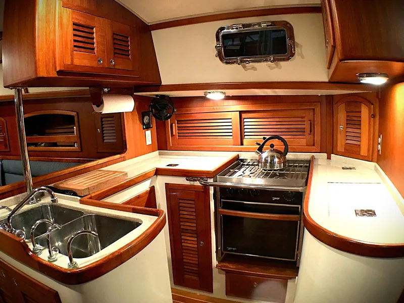 Slide: The Image of Luxurious 2005 Pacific Seacraft 40 yacht kitchen with wood cabinetry and modern appliances. - 8