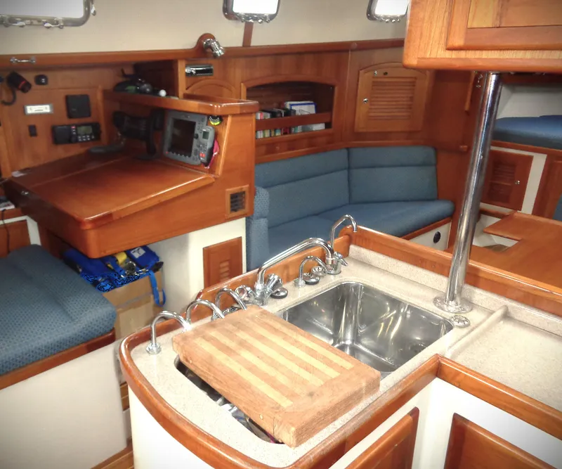 Slide: The Image of Interior of 2005 Pacific Seacraft 40 sailboat with kitchen and seating area. - 9