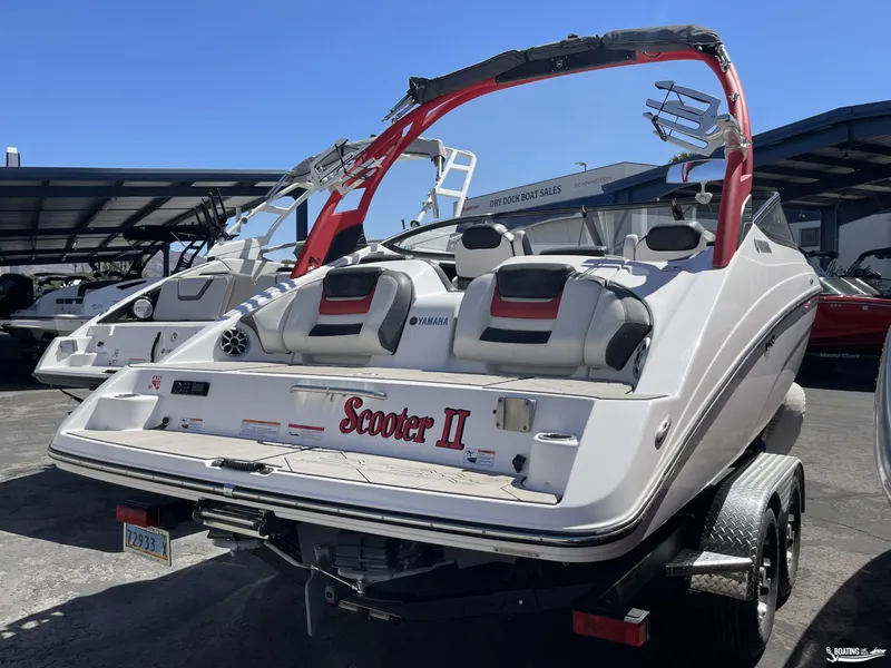 Slide: The Image of 2020 Yamaha Boats 212X in a boat dealership lot. - 1