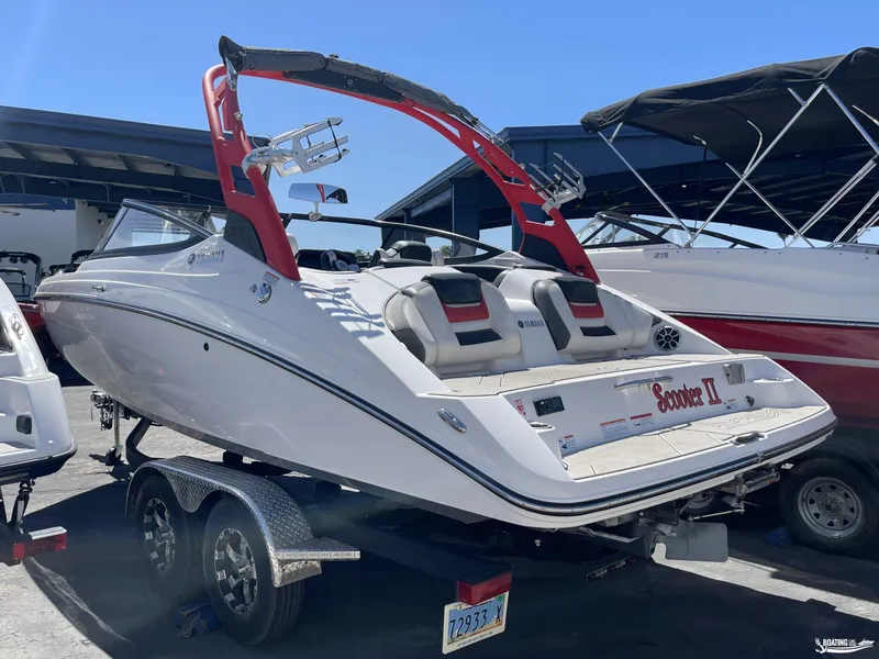 Slide: The Image of 2020 Yamaha Boats 212X on trailer, rear view, in marina. - 2