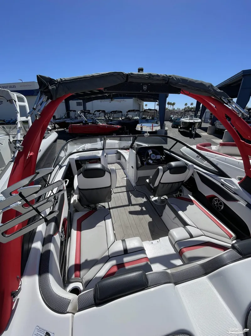 Slide: The Image of 2020 Yamaha Boats 212X interior with red and white seating, steering console, and wakeboard tower. - 3