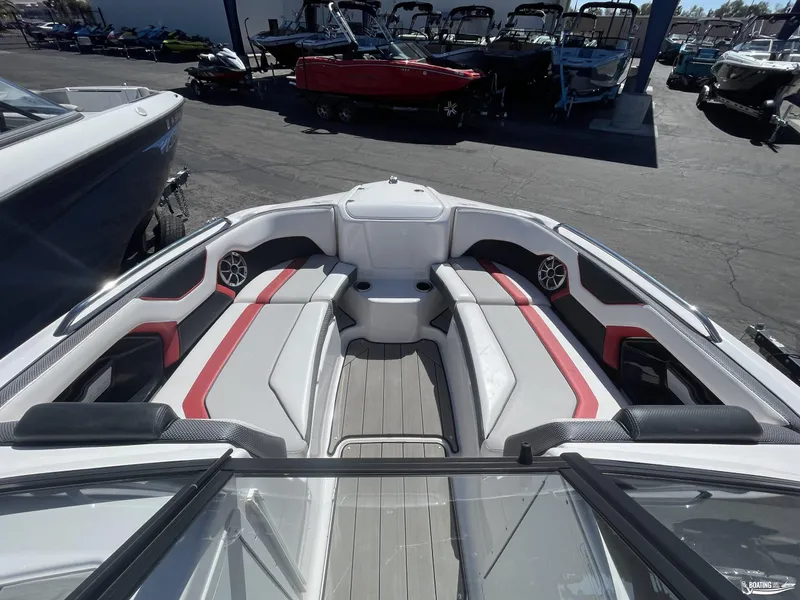 Slide: The Image of 2020 Yamaha Boats 212X interior with red and white seating, docked among other boats. - 6