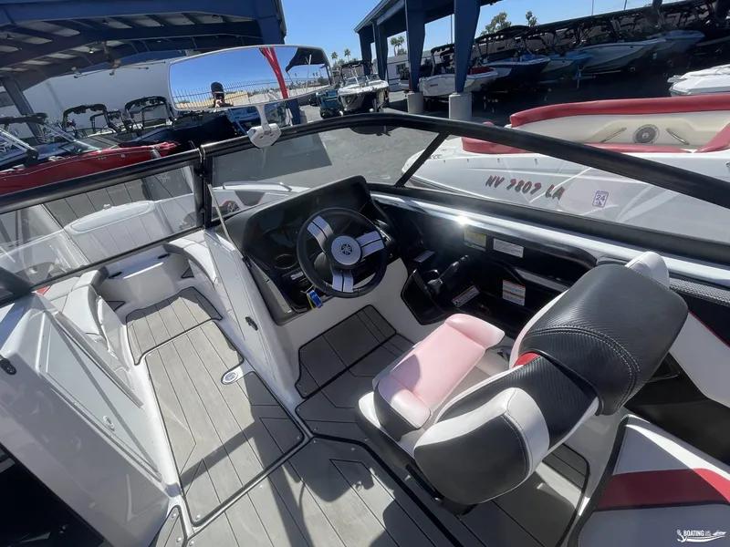 Slide: The Image of 2020 Yamaha Boats 212X interior cockpit with steering wheel and seating. - 7
