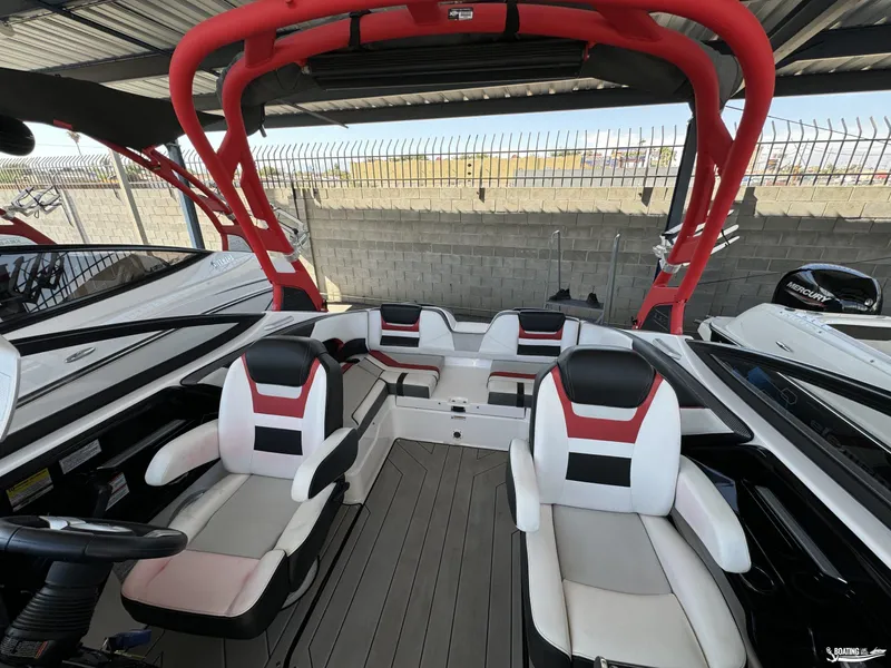 Slide: The Image of 2020 Yamaha Boats 212X interior with red accents and modern seating design. - 8