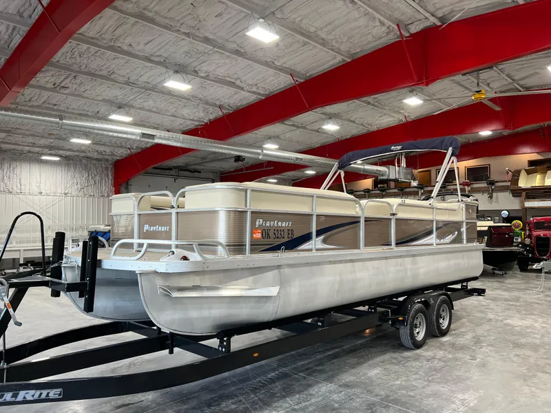 The Image of 2013 PlayCraft 2400 Clipper pontoon boat on trailer in indoor storage facility. - 0