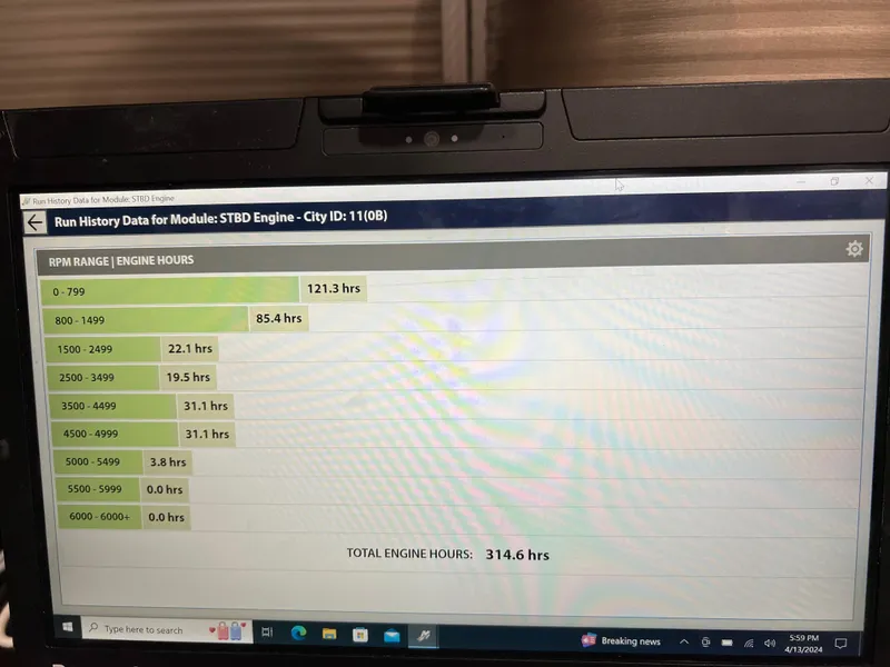 Slide: The Image of Engine run history data displayed on a laptop screen for a 2013 PlayCraft 2400 Clipper. - 12
