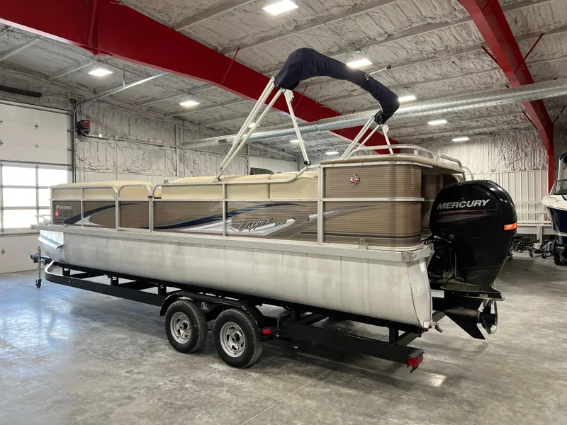 Slide: The Image of 2013 PlayCraft 2400 Clipper pontoon boat on trailer in indoor storage. - 2