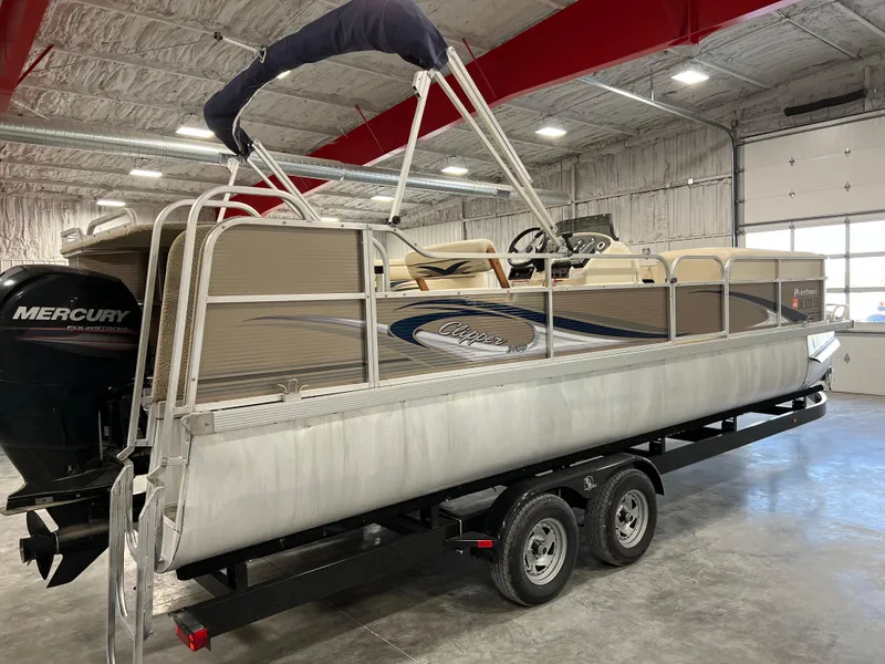 Slide: The Image of 2013 PlayCraft 2400 Clipper pontoon boat on trailer in indoor storage. - 3