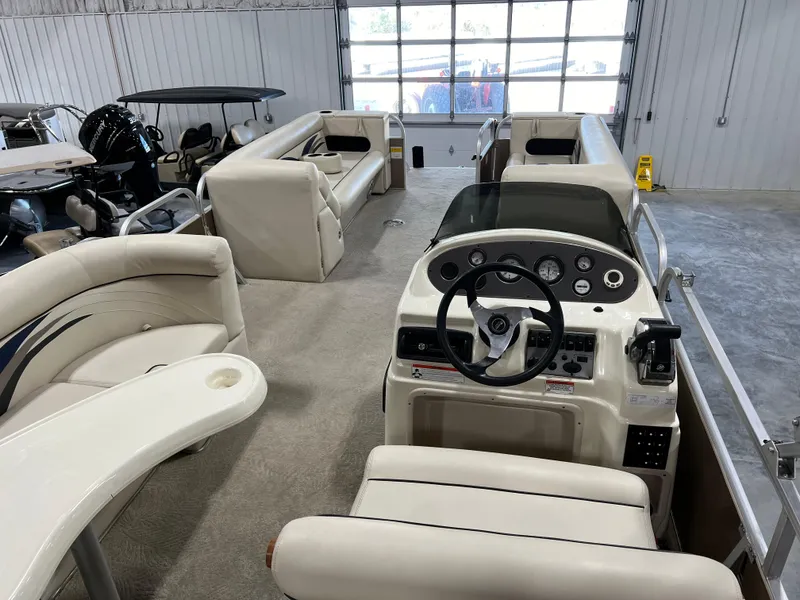 Slide: The Image of 2013 PlayCraft 2400 Clipper pontoon boat interior with helm and seating. - 6