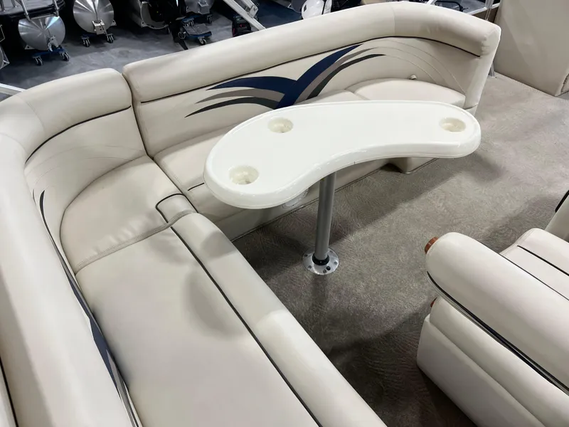 Slide: The Image of 2013 PlayCraft 2400 Clipper boat interior with curved seating and table. - 9