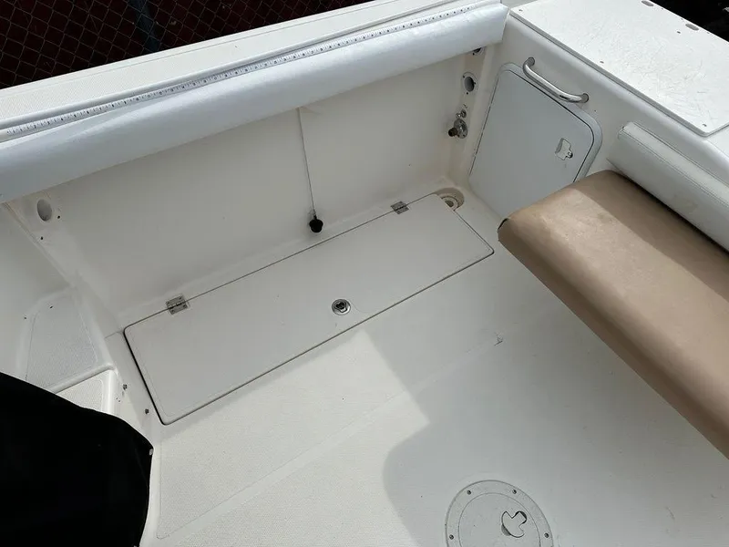 Slide: The Image of 2012 Striper 2601 Walkaround boat interior with storage compartments and seating. - 10