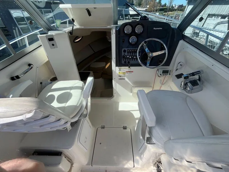 Slide: The Image of Interior of a 2012 Striper 2601 Walkaround boat with steering console and seating. - 15