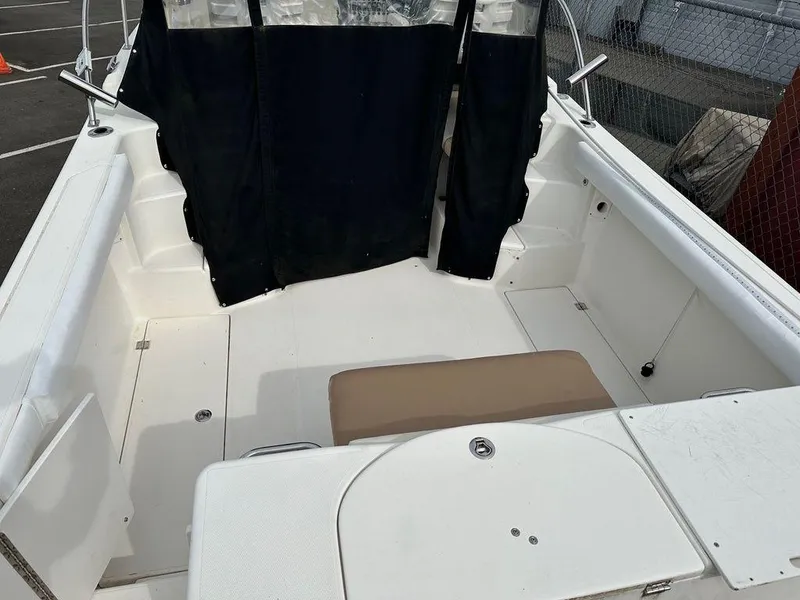 Slide: The Image of 2012 Striper 2601 Walkaround boat interior with seating and black curtain. - 7