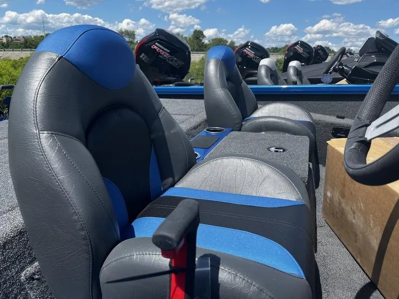 Slide: The Image of 2024 Vexus AVX 1980 boat interior with blue and gray seats, cup holders, and steering wheel. - 5