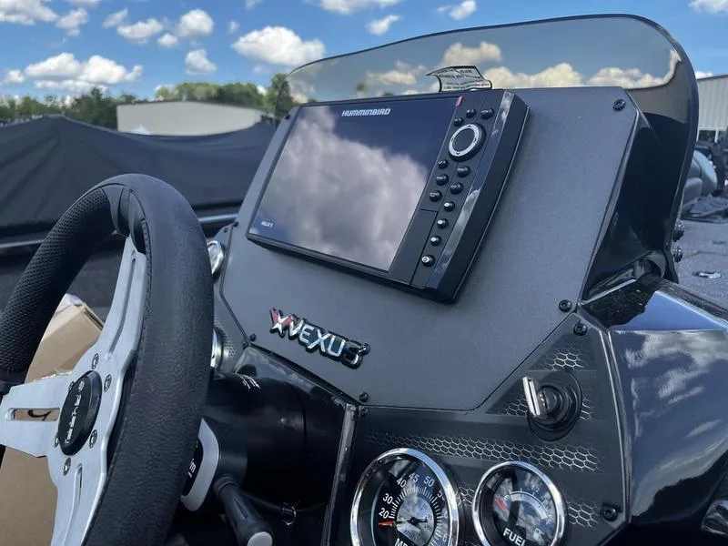 Slide: The Image of 2024 Vexus AVX 1880 boat dashboard with Humminbird fishfinder and steering wheel. - 4