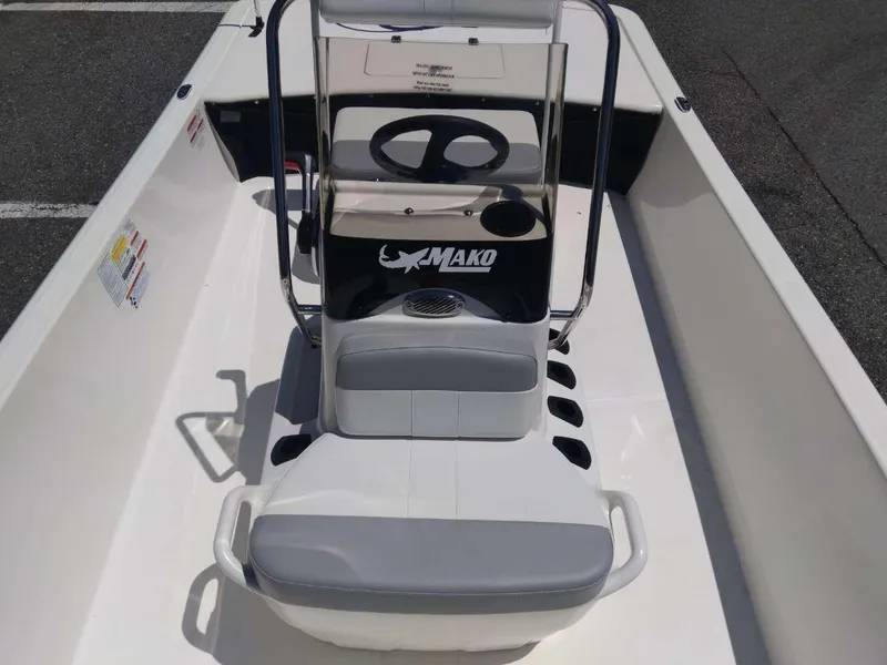 Slide: The Image of 2024 Mako Pro Skiff 17 CC center console boat interior with steering wheel. - 11