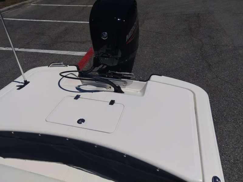 Slide: The Image of 2024 Mako Pro Skiff 17 CC boat with Mercury outboard motor in parking lot. - 14