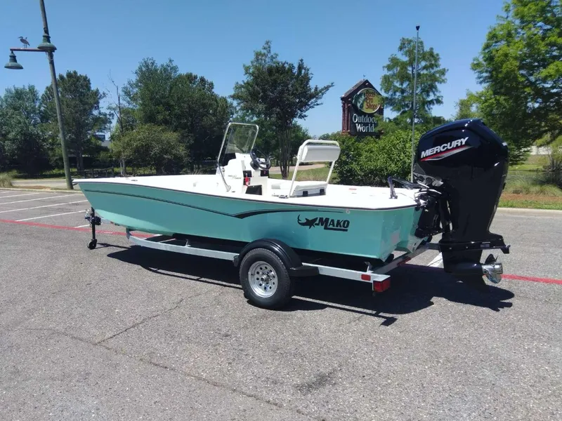 Slide: The Image of 2024 Mako Pro Skiff 17 CC boat on trailer with Mercury outboard motor. - 2