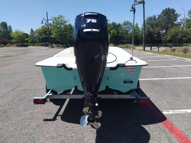 Slide: The Image of 2024 Mako Pro Skiff 17 CC with Mercury 75 engine on trailer in parking lot. - 3