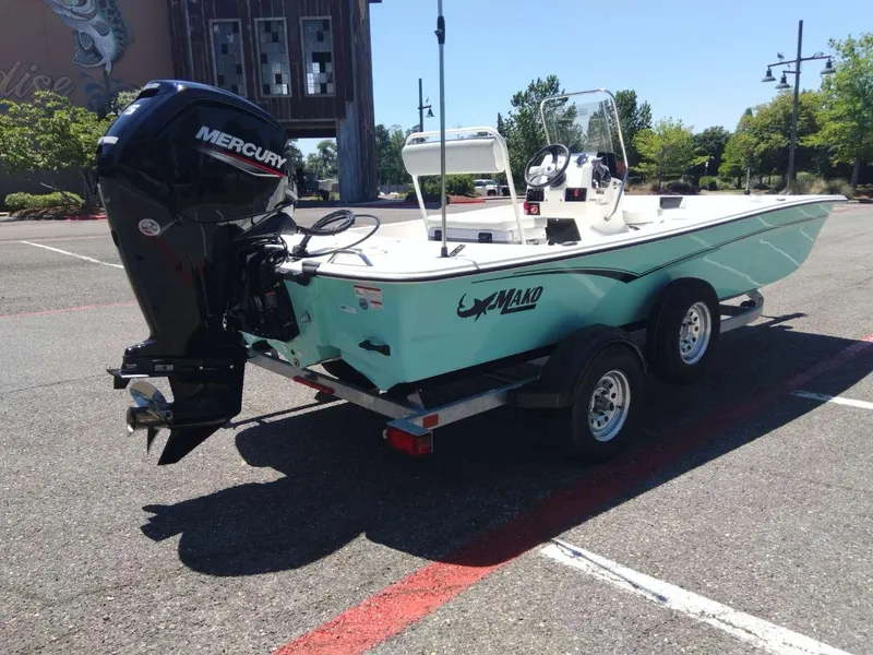 Slide: The Image of 2024 Mako Pro Skiff 17 CC boat with Mercury outboard motor on trailer. - 4