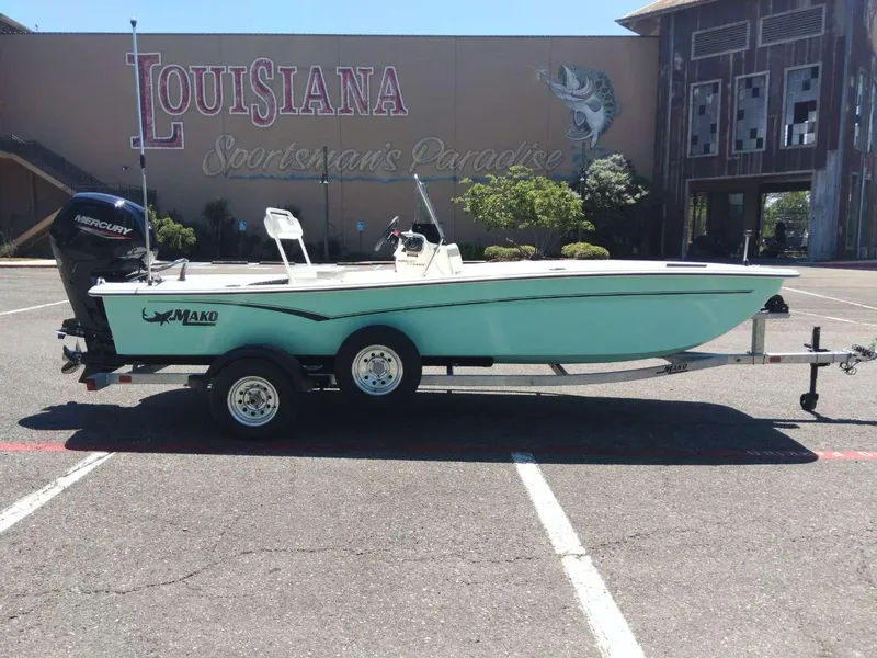 Slide: The Image of 2024 Mako Pro Skiff 17 CC boat on trailer in Louisiana parking lot. - 5