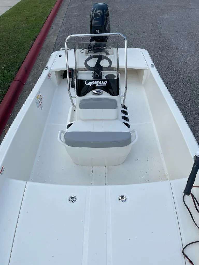 Slide: The Image of 2024 Mako Pro Skiff 15 CC, center console fishing boat, white interior, outboard motor. - 2