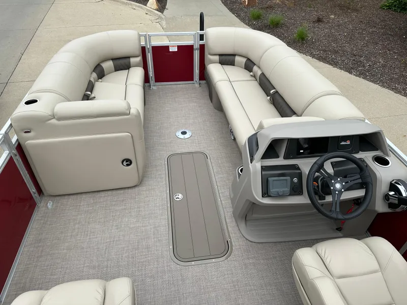 Slide: The Image of 2024 Sun Tracker Party Barge 22 XP3 interior with beige seating and modern helm. - 3