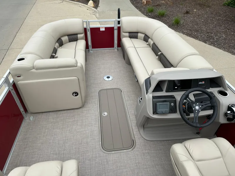 Slide: The Image of 2024 Sun Tracker Party Barge 22 XP3 interior with beige seating and steering console. - 4