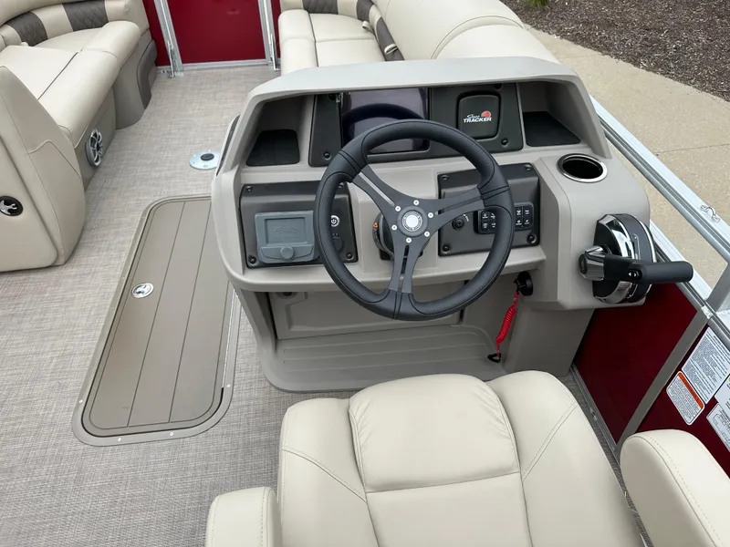 Slide: The Image of 2024 Sun Tracker Party Barge 22 XP3 helm with steering wheel and control panel. - 5