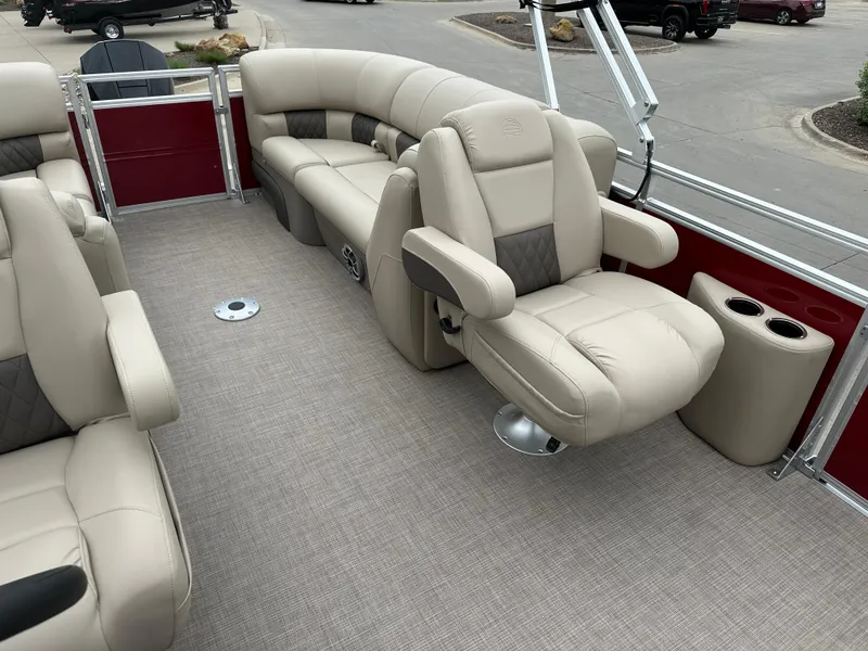 Slide: The Image of 2024 Sun Tracker Party Barge 22 XP3 interior with beige seating and cup holders. - 6