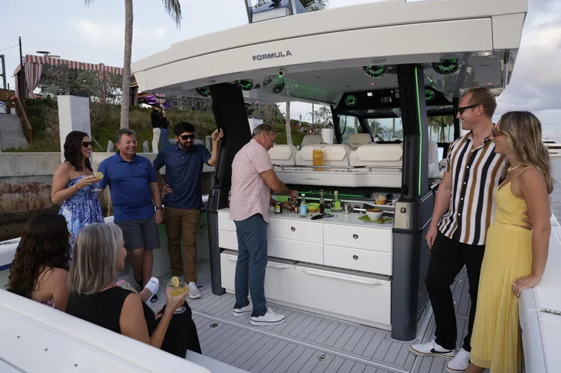 Slide: The Image of Group enjoying on a 2025 Formula 457 Center Console Sport boat. - 10