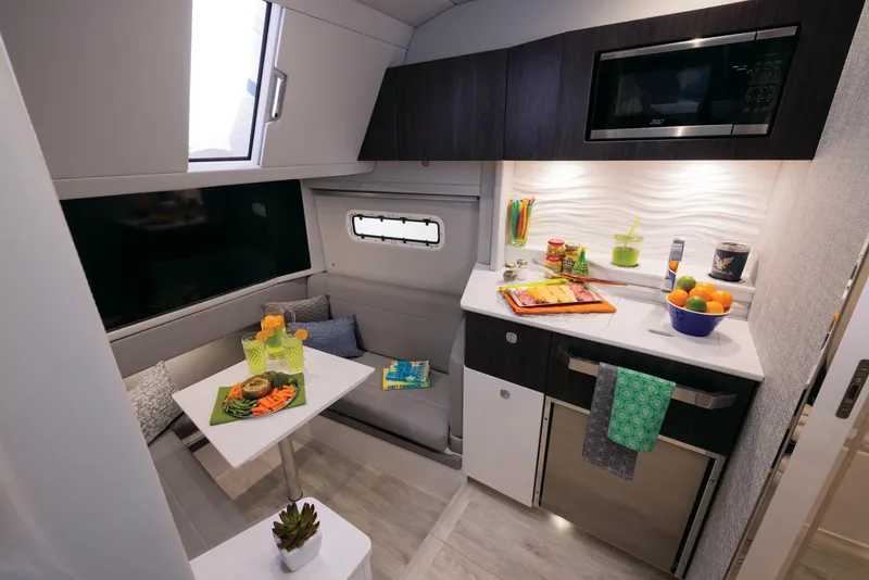 Slide: The Image of Modern interior of 2025 Formula 457 Center Console Sport boat with kitchenette and dining area. - 11