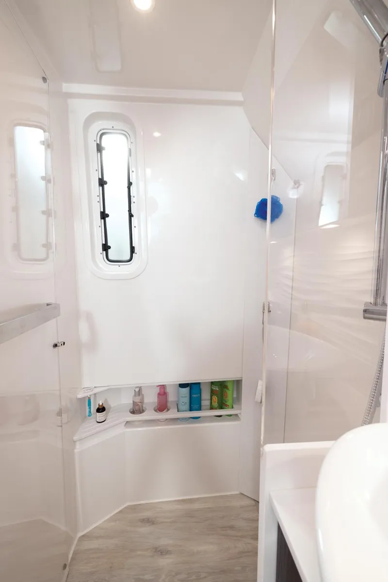 Slide: The Image of 2025 Formula 457 Center Console Sport boat bathroom with modern fixtures and storage shelves. - 15