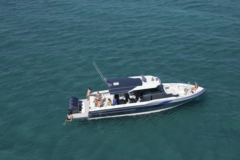 Slide: The Image of 2025 Formula 457 Center Console Sport boat cruising with passengers on clear blue water. - 2