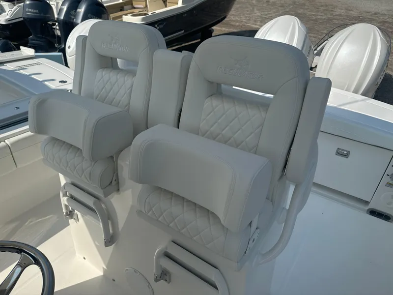 Slide: The Image of 2025 Regulator 28 boat seats with quilted upholstery and armrests. - 13