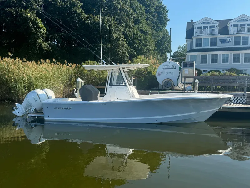 Slide: The Image of 2025 Regulator 28 boat docked near waterfront house. - 4