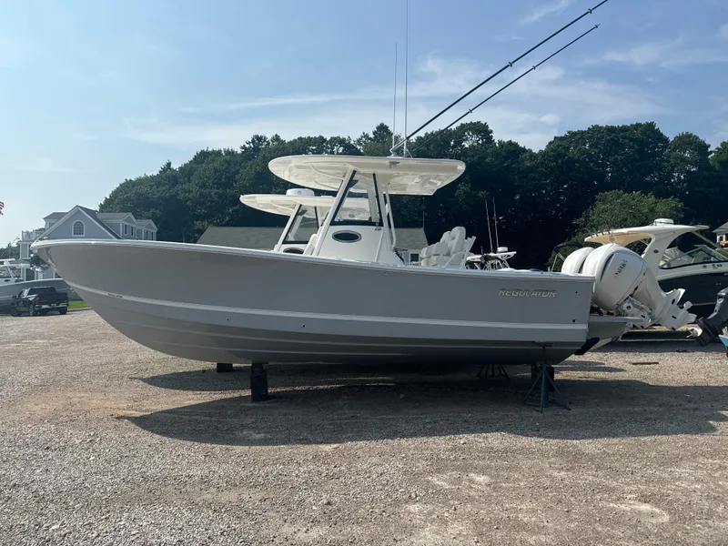 Slide: The Image of 2025 Regulator 28 boat on display in a sunny outdoor setting. - 5