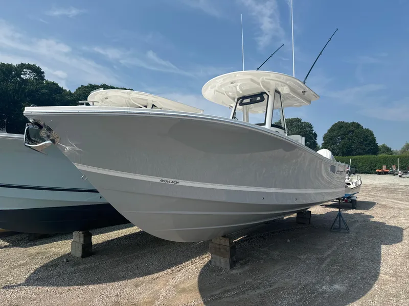 Slide: The Image of 2025 Regulator 28 boat on display, sleek design, parked outdoors. - 6