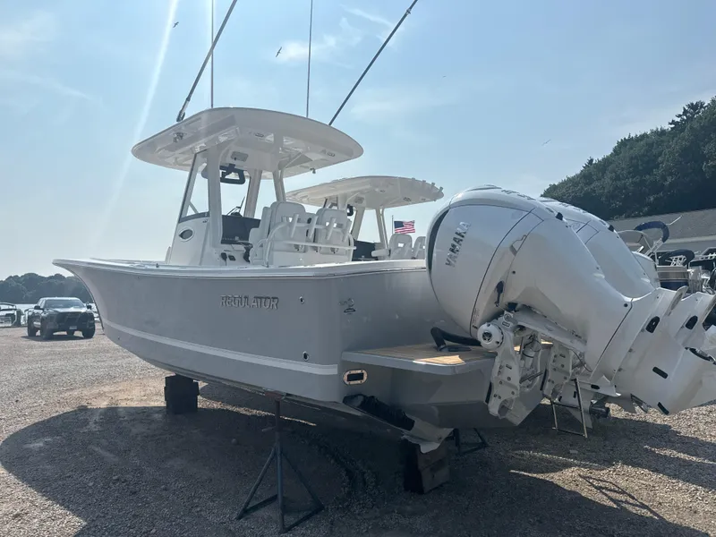 Slide: The Image of 2025 Regulator 28 boat with dual outboard engines on a sunny day. - 7